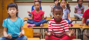 diversity-of-kids-meditating-during-yoga