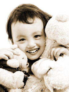 Cute Young Girl Hugging Two Teddy Bears